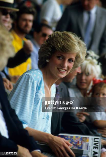 Princess Diana watches from the crowd during the Live Aid concert at Wembley Stadium in London, 13th July 1985. The concert raised funds for famine...