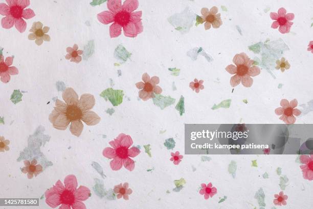 handmade recycled flower and leaf paper background. - mulberry bush stock-fotos und bilder