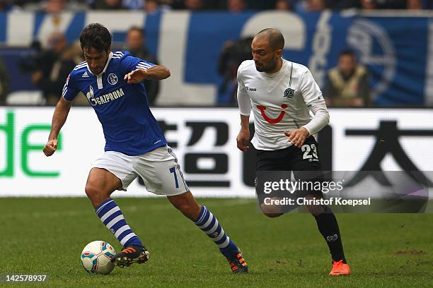 Sofian Chahed of Hannover challenges Raul Gonzalez of Schalke during the Bundesliga match between FC Schalke 04 and Hanover 96 at Veltins Arena on...