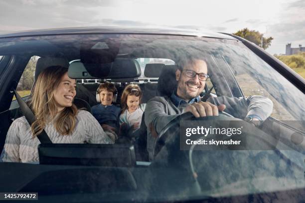 happy family enjoying while going on a vacation by car. - car stockfoto's en -beelden