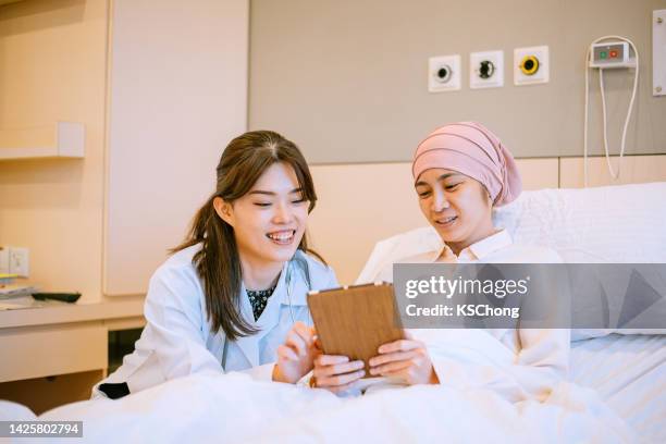 asian doctor treat patient as a friend - patient history stock pictures, royalty-free photos & images