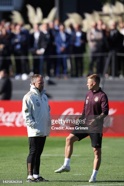 Head coach Hans-Dieter Flick talks to Joshua Kimmich during for a Germany training session at DFB-Campus on September 21, 2022 in Frankfurt am Main,...