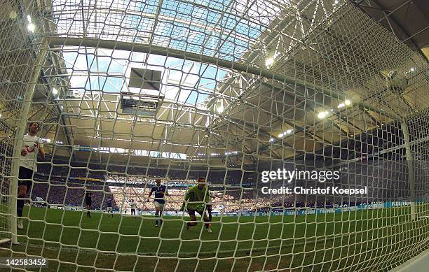 Klaas-Jan Huntelaar of Schalke scores the third goal against Ron-Robert Zieler of Hannover during the Bundesliga match between FC Schalke 04 and...