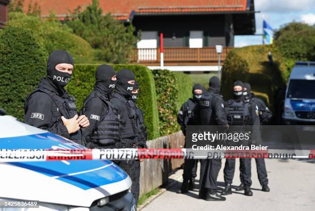 Police stand outside a Tegernsee lakeside villa of Russian oligarch Alisher Usmanov during a police raid on September 21, 2022 in Rottach-Egern,...
