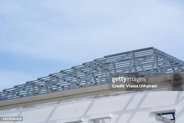 roof frame truss on construction site,new residential construction house framing,house under construction. - roof truss stock pictures, royalty-free photos & images