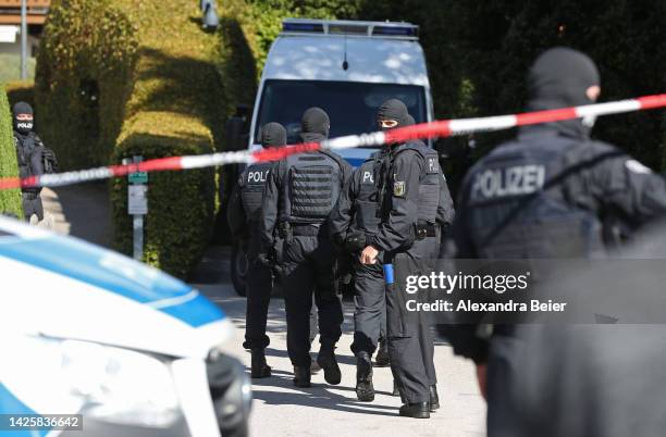 Police stand outside a Tegernsee lakeside villa of Russian oligarch Alisher Usmanov during a police raid on September 21, 2022 in Rottach-Egern,...