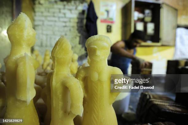 An Egyptian factory worker forms candy dolls in preparation for the upcoming Mawlid celebrations , at a traditional factory in Bab al-Bahr district...