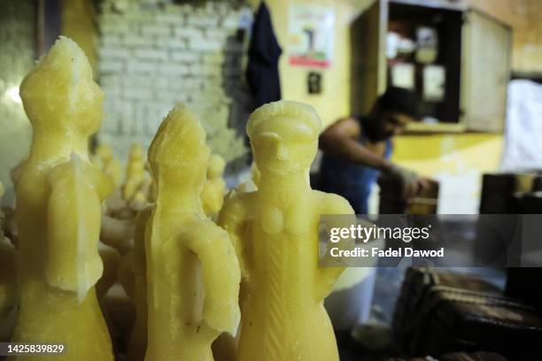 An Egyptian factory worker forms candy dolls in preparation for the upcoming Mawlid celebrations , at a traditional factory in Bab al-Bahr district...