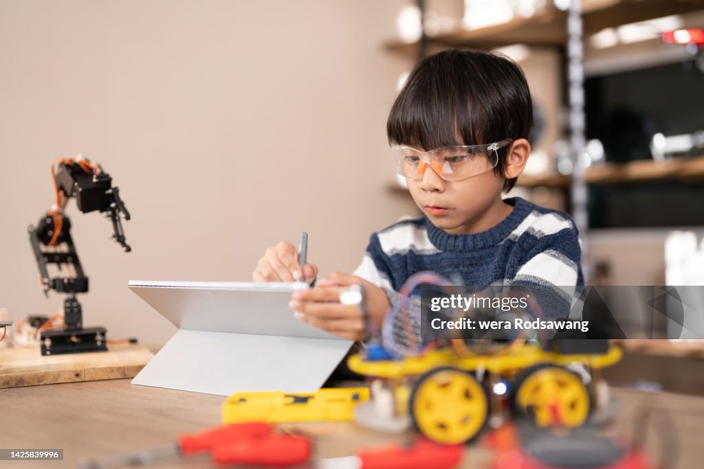 Create Robot Programs A Boy Practice Build Robots Use Software To Code And Program High-Res ...