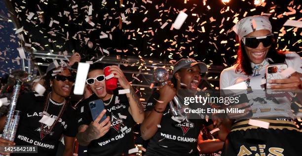 Confetti falls around Aisha Sheppard, Kierstan Bell, Chelsea Gray and A'ja Wilson of the Las Vegas Aces as they celebrate onstage during the team's...