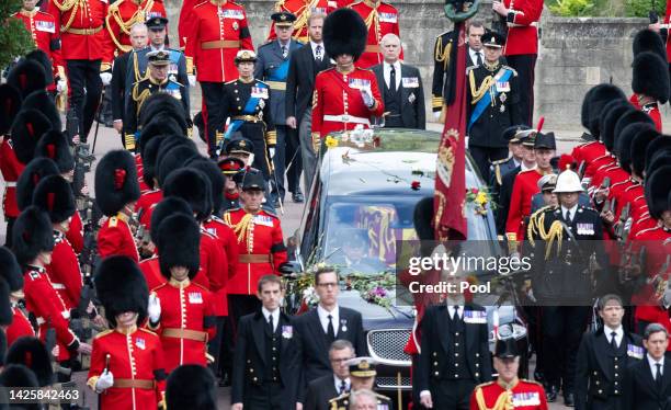 The coffin of Queen Elizabeth II is carried in The state hearse as it proceeds towards St. George's Chapel followed by Prince Edward, Earl of Wessex,...