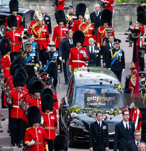 The coffin of Queen Elizabeth II is carried in The state hearse as it proceeds towards St. George's Chapel followed by Prince Edward, Earl of Wessex,...