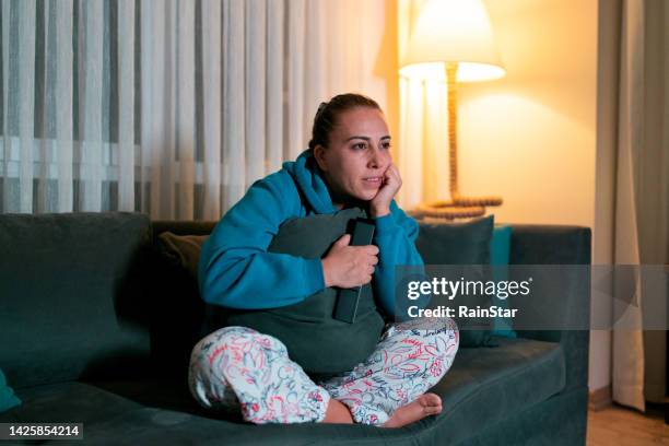 woman watching tv at home - reality tv stock pictures, royalty-free photos & images