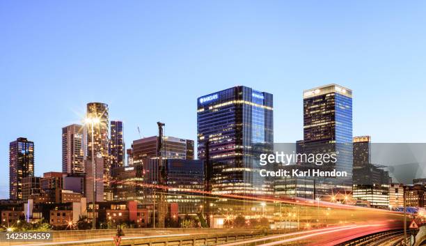 an elevated view of the canary wharf skyline, london - dusk - sunset on canary wharf stock pictures, royalty-free photos & images