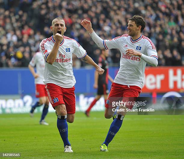 Mladen Petric of Hamburg celebrates scoring his goal with Marcus Berg during the Bundesliga match between Hamburger SV and Bayer 04 Leverkusen at...