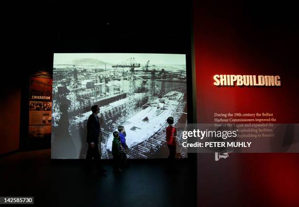 Visitors view a display on shipbuilding on March 27, 2012 in the Titanic Belfast visitor center in Belfast, Northern Ireland. A century after the...