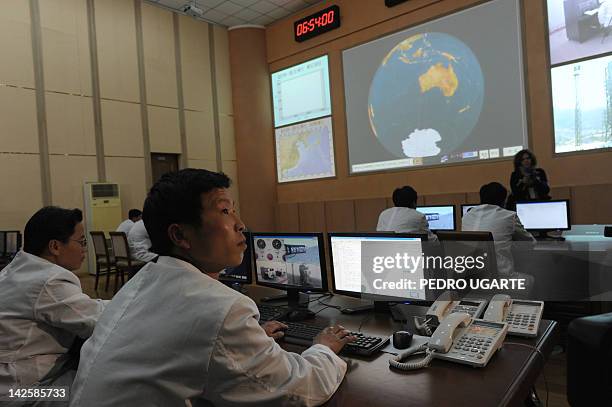 North Korean technicians work at the control room of the Tongchang-ri space center on April 8, 2012. North Korea's long-range rocket is on its launch...