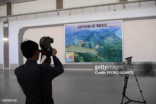 North Korean cameraman films a map with the site of launch pad of the rocket Unah-3 at the Tongchang-ri space center on April 8, 2012. North Korea's...