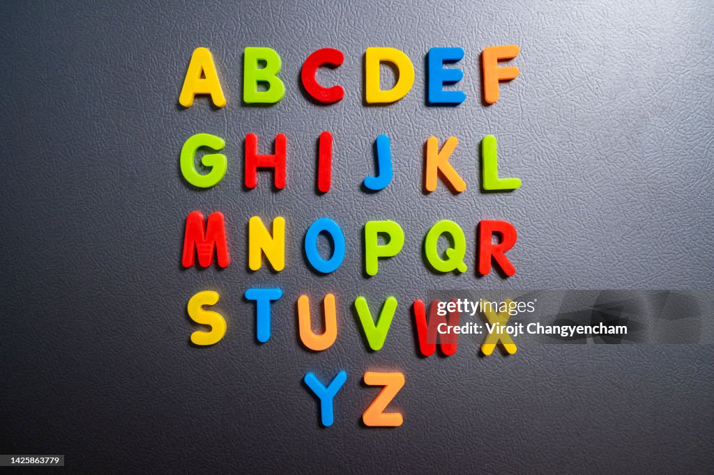 Magnetic letters on a fridge door, kids learning with word combination at home concept.