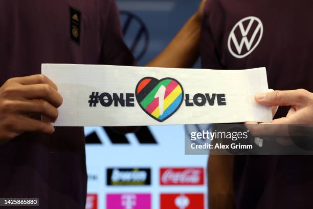 Thilo Kehrer and Jonas Hofmann pose with the team's captain's armband for the FIFA World Cup Qatar 2022 during a Germany press conference at...