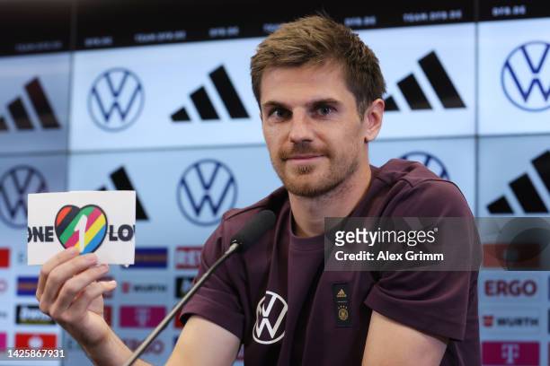 Jonas Hofmann presents the team's captain's armband for the FIFA World Cup Qatar 2022 during a Germany press conference at DFB-Campus on September...