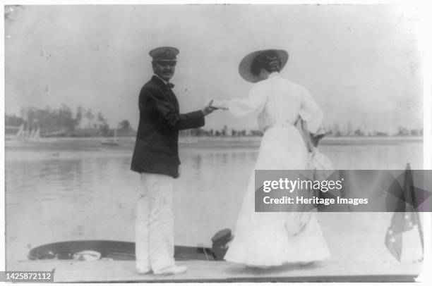 Man assisting woman into boat, Oyster Bay, Long Island, N.Y., 1905. Artist Frances Benjamin Johnston.
