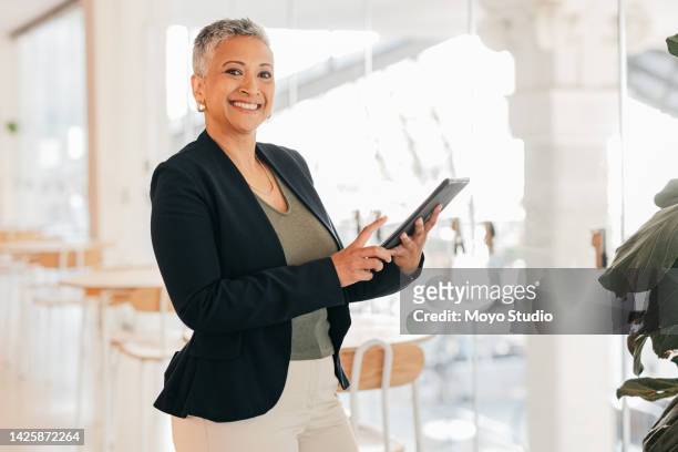 business woman, tablet and motivation in a startup digital marketing office. smile portrait of happy employee, leader and manager with company schedule and planning innovation idea on technology - executive smile pointing bildbanksfoton och bilder