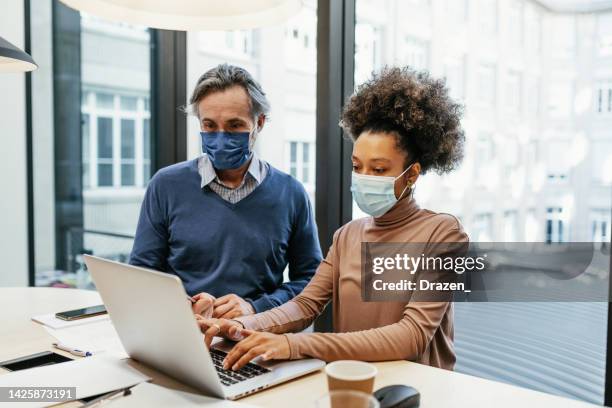 financial experts working together in office and analysing market performance - employee engagement mask stock pictures, royalty-free photos & images
