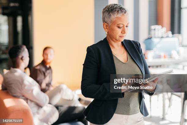 leader and business woman on a digital tablet in a modern corporate office. mature confident entrepreneur feeling ambitious and motivated for success while planning schedule online with app at work - about us stock pictures, royalty-free photos & images