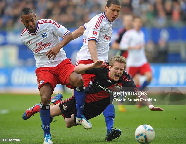 Andre Schuerrle of Leverkusen is challenged by Dennis Aogo and Jeffery Bruma of Hamburg during the Bundesliga match between Hamburger SV and Bayer 04...