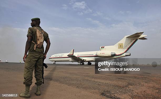 Malian soldier stands on the tarmac on April 7, 2012 as the plane carrying Malian Parliament Speaker Dioncounda Traore lands at the Bamako airport...