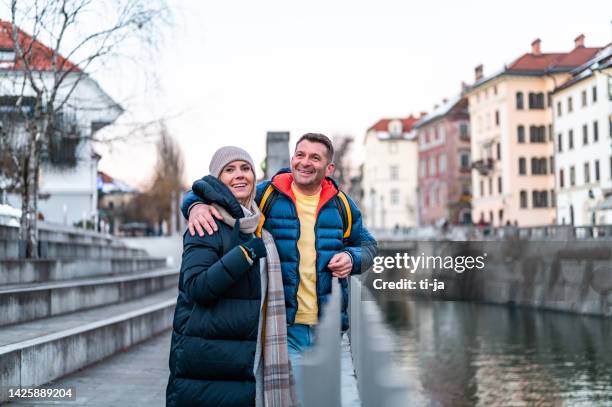 couple enjoying in the city in a wintertime - mature couple winter outdoors stock pictures, royalty-free photos & images