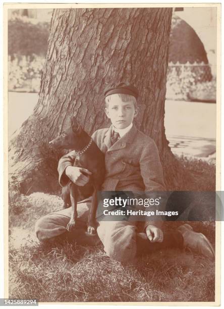 Kermit Roosevelt and Jack, the dog, 1902. Photograph shows Kermit Roosevelt holding his dog and sitting under a tree. [Son of President Theodore and...