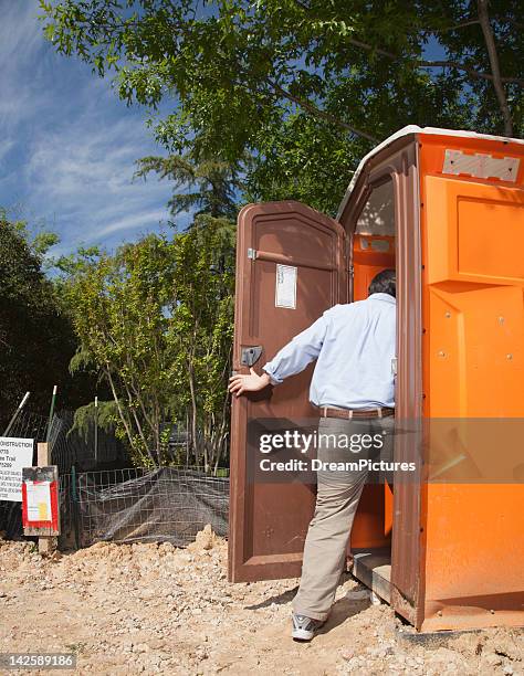 man entering portable toilet - mietklo stock-fotos und bilder