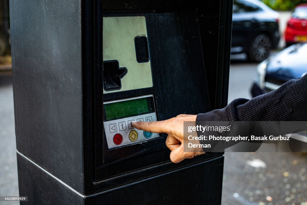 A man paying for parking at the automatic payment machine