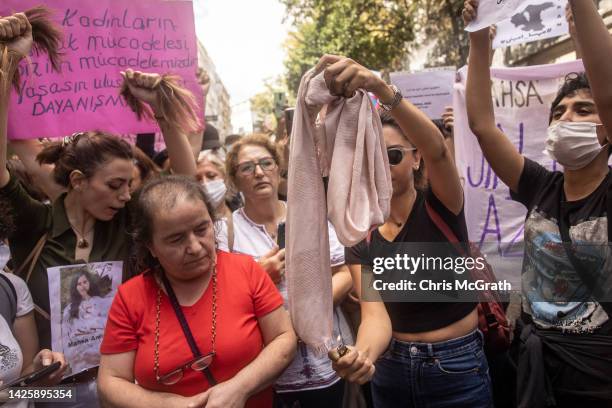Woman sets fire to her headscarf during a protest over the death of Iranian Mahsa Amini outside the Iranian Consulate on September 21, 2022 in...