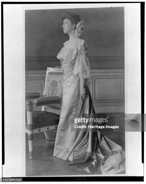 Alice Roosevelt Longworth, full-length portrait, standing next to chair, facing left, 1903. [Daughter of President Theodore Roosevelt and his first...