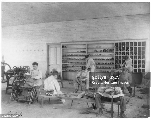 Classroom scenes at Carlisle, Pa., Indian School. Shoe making and repairing; male students, 1901. Artist Frances Benjamin Johnston.