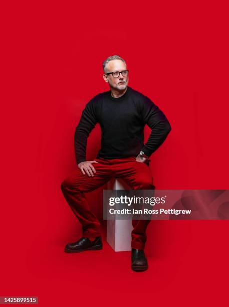 middle-aged man on red background, hands on hips - man portrait full body 50's stock-fotos und bilder