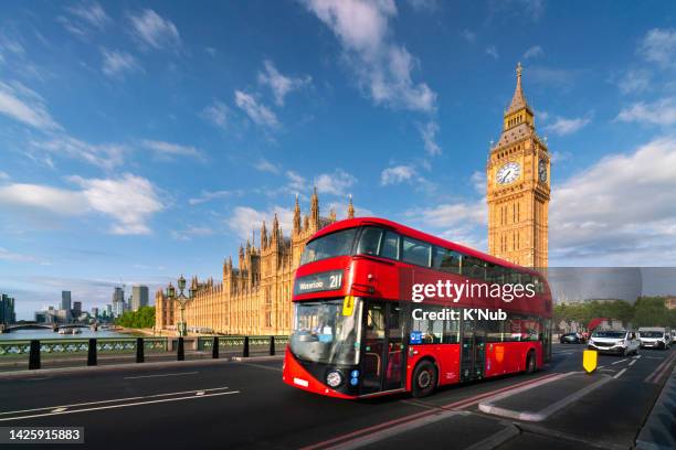 palace of westminster with big ben tower clock or elizabeth bell and red big bus for passenger public transportation in london, great britain, england of united kingdom, uk - london red bus photos et images de collection