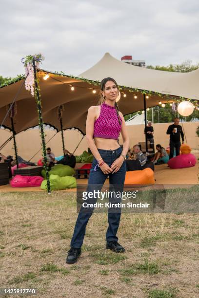 Isabella Charlotta Poppius wears Adidas trainers, Frame denim jeans, Versace top and a Valentino Rockstud bracelet at Victoria Park on August 26,...