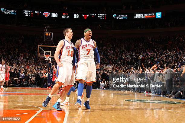 Carmelo Anthony of the New York Knicks, who has hit two last second shots to win in overtime, celebrates victory with Steve Novak of the New York...