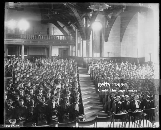 Interior view of chapel filled with female students at the Tuskegee Institute, circa 1902. [Young black women at a church service]. Artist Frances...