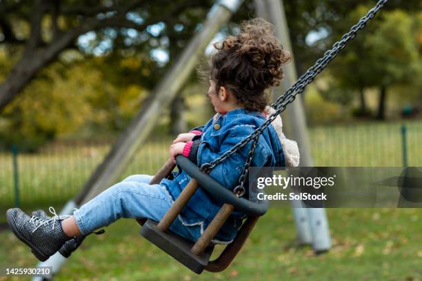 solo swinging - playground stock pictures, royalty-free photos & images