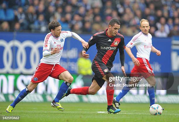 Marcus Berg of Hamburg challenges Renato Augusto of Leverkusen during the Bundesliga match between Hamburger SV and Bayer 04 Leverkusen at Imtech...