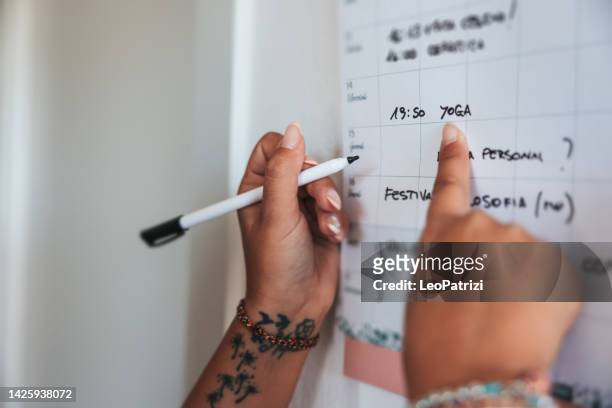 woman make a reminder on the next yoga class - week schedule stock pictures, royalty-free photos & images