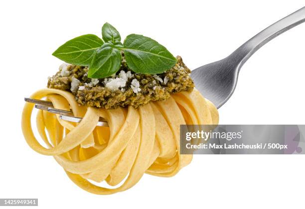 fettuccine on fork,spaghetti isolated on white background - フェットチーネ ストックフォトと画像