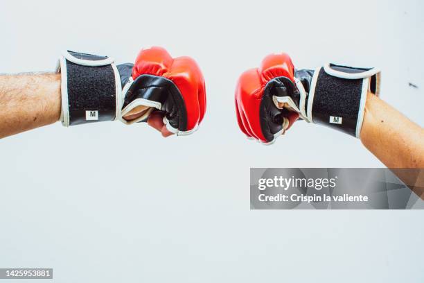 mma training, hands with boxing gloves on white background. - kick boxing fotografías e imágenes de stock