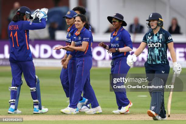 Renuka Singh Thakur of India celebrates with team mates after taking the wicket of India's Emma Lamb during the 2nd Royal London ODI between England...