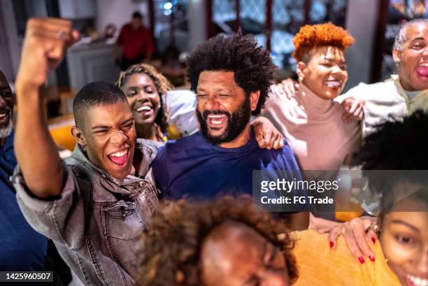 sports fans watching a match and celebrating at a bar - cas awards stock pictures, royalty-free photos & images